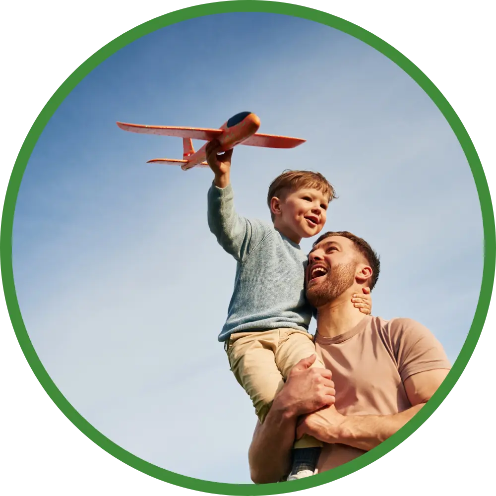 Dad with son flying toy plane