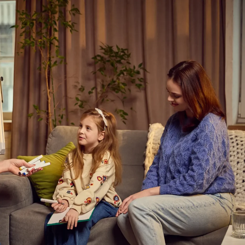Mum sitting with daughter in therapy session
