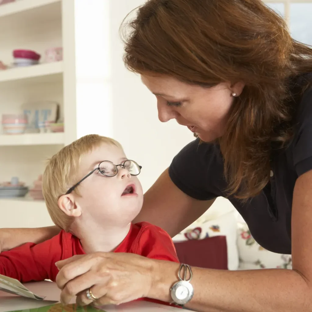 Therapist working with disabled child